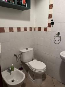 a bathroom with a toilet and a sink at La Casina - Borgo di Bibbona in Bibbona