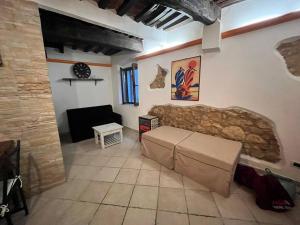 a living room with a couch and a table at La Casina - Borgo di Bibbona in Bibbona