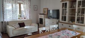 a living room with a couch and a tv and a table at Juli's Place in Rovinjsko Selo