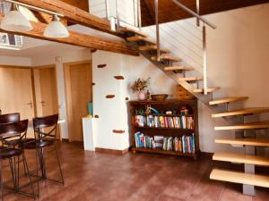a living room with a staircase and a book shelf at Guesthouse ''Chatonnaye'' in Châtonnaye