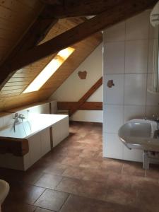 a bathroom with a sink and a bath tub at Guesthouse ''Chatonnaye'' 