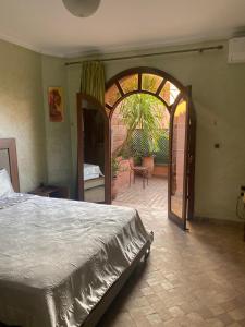 a bedroom with a large bed and an open doorway at Villa a Marrakech in Marrakesh