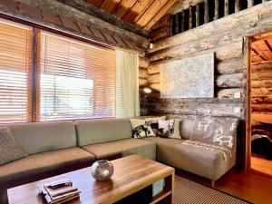 a living room with a couch and a table at Villa Saarua by the Slopes Ski in, Family & Bike Park, hike trails, National Park, WiFi - Lapland Villas in Ruka +115 photos