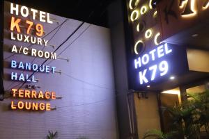 a building with neon signs on the side of it at HOTEL K79 in Jamshedpur