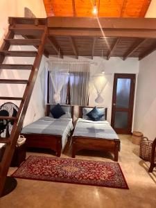 a bedroom with two beds and a staircase in it at Colonial Residence Kandy in Kandy