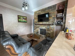 a living room with a couch and a fireplace at Douja Ferme in Ouirgane