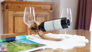 a bottle of wine sitting on a table with two glasses at Villa Eisl-Raudaschl in St. Wolfgang