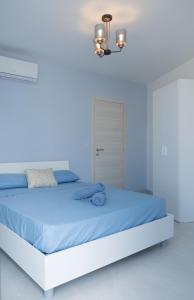 ein blaues Schlafzimmer mit einem Bett mit blauer Bettwäsche in der Unterkunft Side-seaview apartment near beach and close to St. Julians in Baħar iċ-Ċagħaq