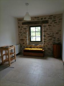 a room with a bed and a window at Relais du lac de la Truyère in Anglards-de-Saint-Flour