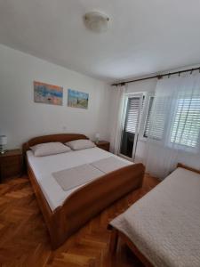 Postel nebo postele na pokoji v ubytování Apartman Frketić