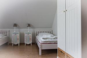 a bedroom with a bed and two night stands at Staberhuk Baben - großer sonniger Balkon - XL Wohnung in Staberdorf