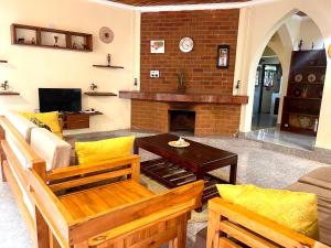 a living room with a couch and a fireplace at Toiwo Residence Arusha in Arusha