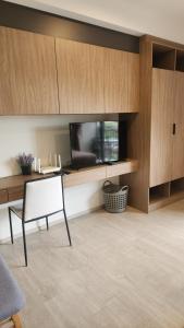 a living room with a flat screen tv and a chair at Apple's La casita condo in Hua Hin in Hua Hin