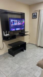 a living room with a flat screen tv on a wall at Las Rejas Departamento in San Fernando del Valle de Catamarca