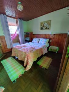 an aerial view of a bedroom with a bed at Pousada Solar das Flores in Visconde De Maua