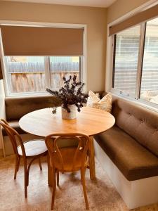 a dining room with a table and chairs and a window at Adventure Bay Holiday Home in Adventure Bay