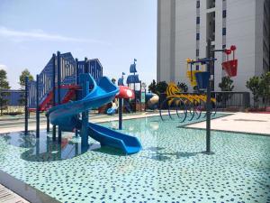 a playground with a slide in the water at Horizon Suites Sepang - Studio Unit in Kampong Melot