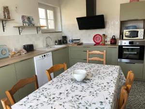 una cucina con tavolo e ciotola di Maison familiale 8 p en vallée de Dordogne - Lot a Tauriac