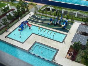 an overhead view of a pool with a water park at Horizon Suites Sepang - Studio Unit in Kampong Melot