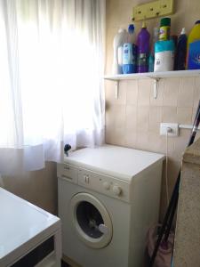a laundry room with a washing machine and a window at Apartamento con vistas al mar y buena ubicación in Benicàssim