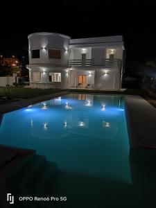 a house with a swimming pool at night at Al Mare da Francesca in Olbia