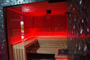 a hot tub with red lights in a room at Pyszna Stajenka in Bąków