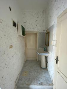 a small bathroom with a sink and a toilet at Abuawad Rental in Jerash