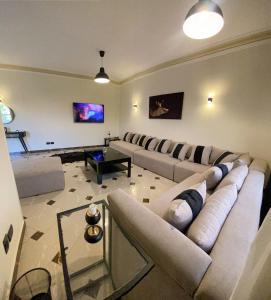 a living room with a couch and a table at 3BD apartment in family house with private garden view in Cairo