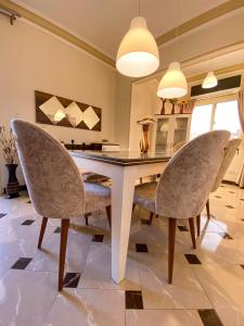 uma sala de jantar com uma mesa branca e cadeiras em Luxury & spacious 3BD Apartment in family house no Cairo