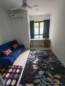 a living room with a couch and a rug at Horizon Suites Sepang - Studio Unit in Kampong Melot