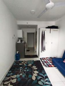 a living room with a rug on the floor at Horizon Suites Sepang - Studio Unit in Kampong Melot
