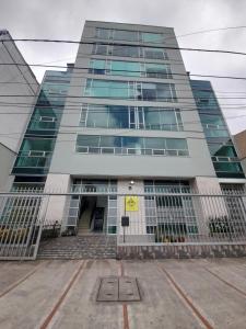 a tall building with a gate in front of it at Hotel Royal Cid Bogota in Bogotá