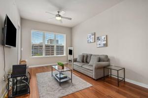 a living room with a couch and a tv at 1 BR Modern Escape Mins fromTX Med Center FREE Parking in Houston