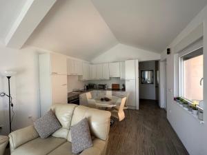 a living room with a couch and a kitchen at Harmony VIR Luxuriös ausgestattete Ferienwohnung mit 65m2 in Vir