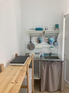 a small kitchen with a counter and a sink at Casa VersoMare Rooftop in Gagliano del Capo +31 photos