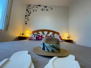 a hat sitting on top of a bed at Apartamentos Vistalmar in Peñíscola +75 photos