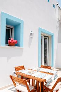 a table and chairs on a patio with a window at Casa VersoMare Rooftop in Gagliano del Capo