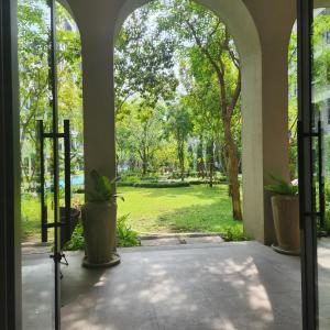 an open door to a patio with a view of a park at Apple's La casita condo Hua Hin room2 in Hua Hin
