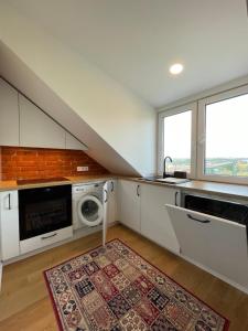 a kitchen with a sink and a microwave at Old Town Apartment with Netflix and AC in Kaunas