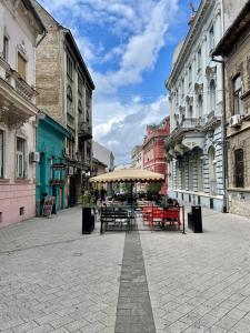 a street with tables and chairs in a city at Alina Urban Getaway in Novi Sad