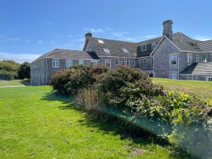 a large house with a yard with plants in front of it at The Downs, Thurlestone, South Devon, close to several beaches in Kingsbridge