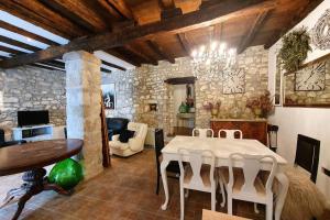 a dining room with a table and chairs in a room at Comfortable stone house apartment 4 persons Poreč, 4km in Musalez
