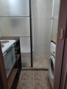 a small bathroom with a washing machine and a washer at Уют и топлина. in Varna City