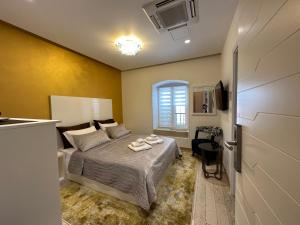 a small bedroom with a bed and a window at B&B Skyfall in Split