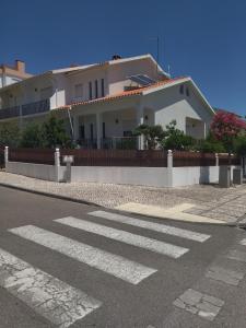 a house with a crosswalk in front of a street at Couto Sá in Entroncamento