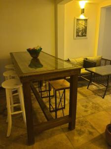 a wooden table with a vase on top of it at The Professor's Hotel in Bodrum City