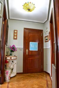 a door with a sign on it in a hallway at Puerta la Villa in Avilés