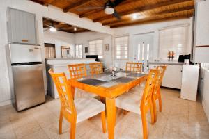 a kitchen with a table and chairs and a refrigerator at Casa Isabel in Rincon