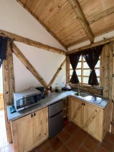 a kitchen with a microwave and a counter top at The Hideout- A Cabin in Nature; 25 min from Cuenca in Cuenca