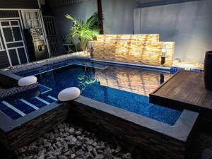 a swimming pool in a house with a table at Casa Dossman in Puntarenas